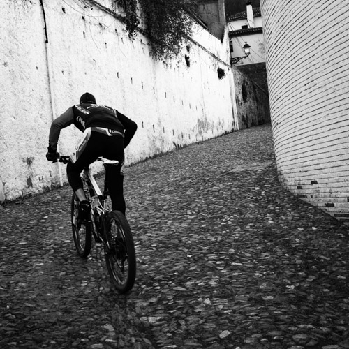 Bicyclist going uphill -- Granada, Spain (2016)